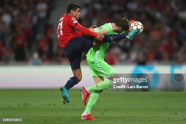 Wout Weghorst of VfL Wolfsburg is challenged by Benjamin Andre of Lille OSC during the UEFA Champions League group G match between Lille OSC and VfL...