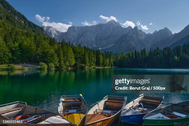 scenic view of lake by mountains against sky,tarvisio,udine,italy - tarvisio stock pictures, royalty-free photos & images