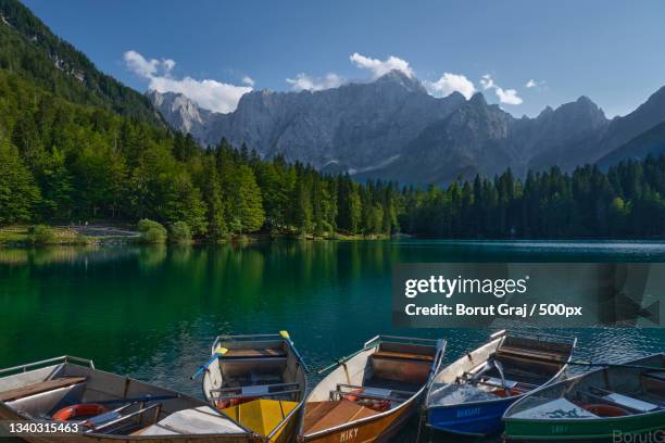 scenic view of lake by mountains against sky,tarvisio,udine,italy - udine stock pictures, royalty-free photos & images