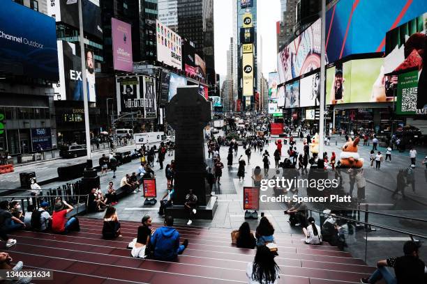 People spend an evening in Times Square as Broadway shows reopen on September 14, 2021 in New York City. Major Broadway shows including The Lion...