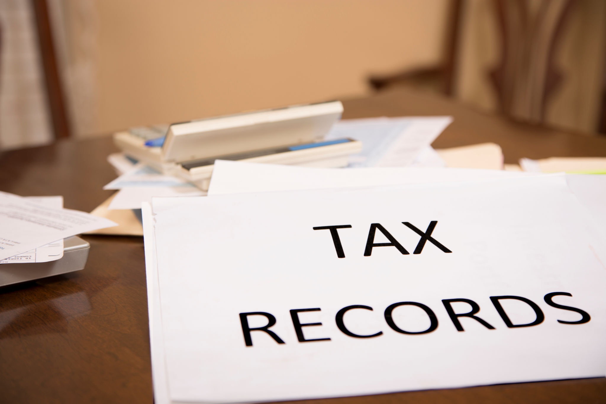 Paperwork scattered on dining table or desk . Income tax filing preparations. Paperwork scattered on dining table or desk . Income tax filing preparations.