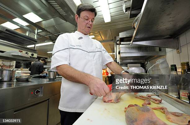 Chef Harald Wohlfahrt prepares pigeons in the kitchen of his restaurant Schwarzwaldstube in the hotel Traube Tonbach in Baiersbronn in the Black...