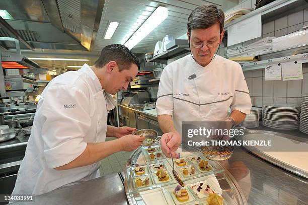 Chef Harald Wohlfahrt, , and his sous-chef Thorsten Michel prepare the amuse gueules in the kitchen of his restaurant Schwarzwaldstube in the hotel...