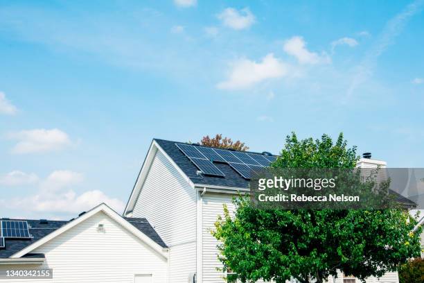 rear view of home with solar panels - casa de dos pisos fotografías e imágenes de stock