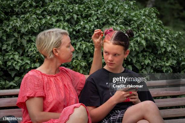 conflict of caring single mother and a irritation teenage daughter in the park - ignoring fotografías e imágenes de stock