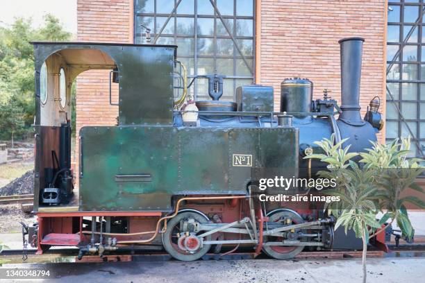 close up of old steam locomotive on display at the station - brick wall brass stock pictures, royalty-free photos & images