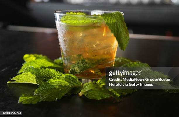 Sheila Gill, manager of Gather food and drink at innovation district hall, shows off a Mint Julep which will be featured at a Kentucky Derby Viewing...