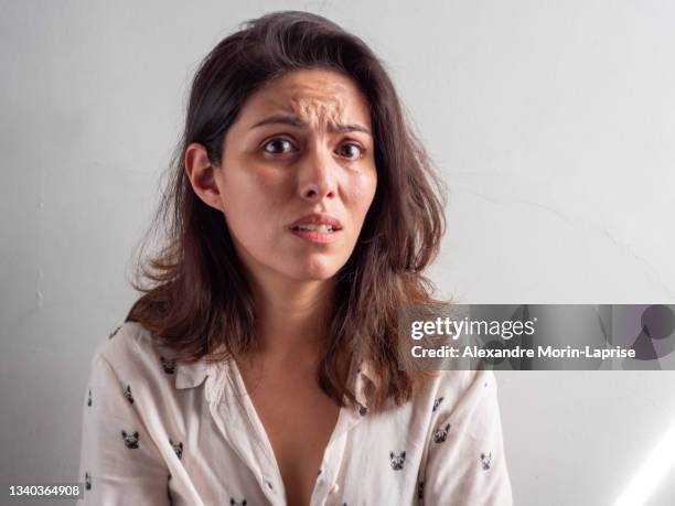 young handsome brown hair peruvian woman looks stressed and affraid - disbelief woman face foto e immagini stock