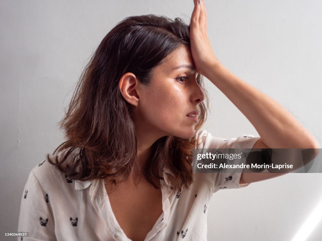 Young Woman Looks Like she Forgot to do Something