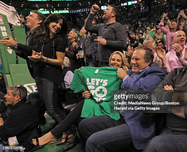 Celtics owner, Wyc Grousbeck's wife Emilia Fazzalari looks back as Linda Holliday and NE Patriots head coach Bill Belichick celebrate during the...
