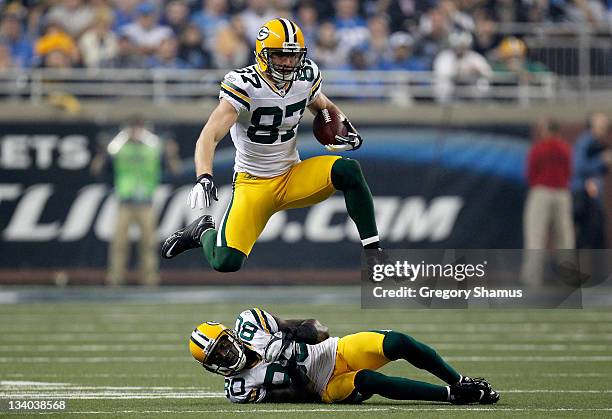 Wide receiver Jordy Nelson of the Green Bay Packers leaps over teammate Donald Driver in the third quarter against the Detroit Lions during the...