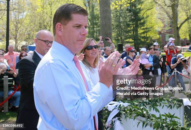 With Four Seasons general manager Bill Taylor, left, and girlfriend Lorrie Higgins, right, at his side, Mayor Marty Walsh claps after the annual...