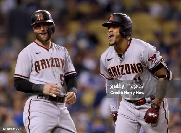Ketel Marte of the Arizona Diamondbacks celebrates his three run homerun with Christian Walker, to trail 6-4 to the Los Angeles Dodgers, during the...