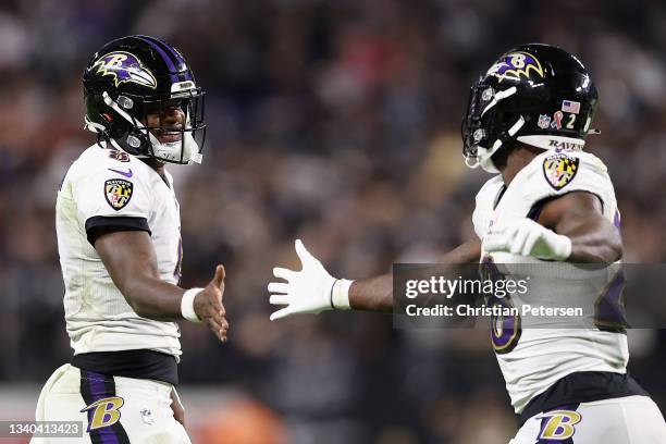 Quarterback Lamar Jackson of the Baltimore Ravens celebrates with Latavius Murray after Murray scored a touchdown against the Las Vegas Raiders in...