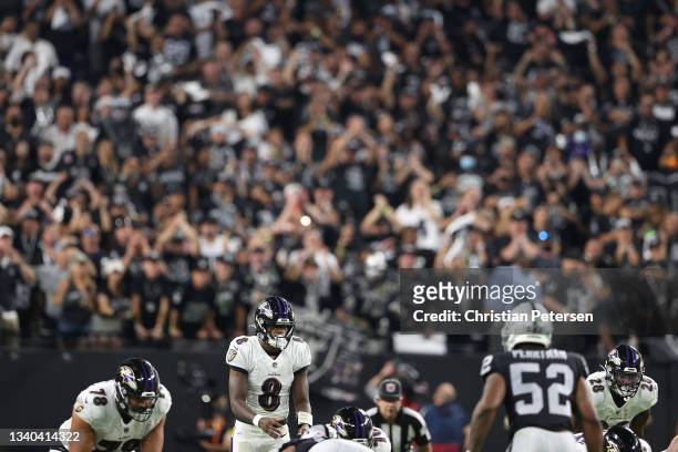 Quarterback Lamar Jackson of the Baltimore Ravens prepares to snap the football during the NFL game against the Las Vegas Raiders at Allegiant...