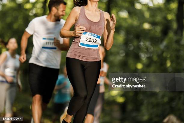 unrecognizable female athlete running a marathon in nature. - halvmaraton bildbanksfoton och bilder