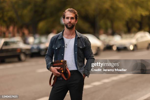 André Hamann wearing a jeans jacket, black pants, a louis vuitton bag on September 11, 2021 in Berlin, Germany.