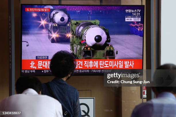 People watch a TV showing a file image of a North Korean missile at the Seoul Railway Station on September 15, 2021 in Seoul, South Korea. The...