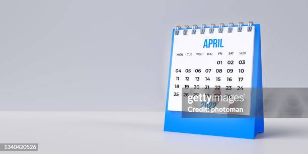 blue april desk calendar 2022 on blank background with copy space. - april fools day stock pictures, royalty-free photos & images