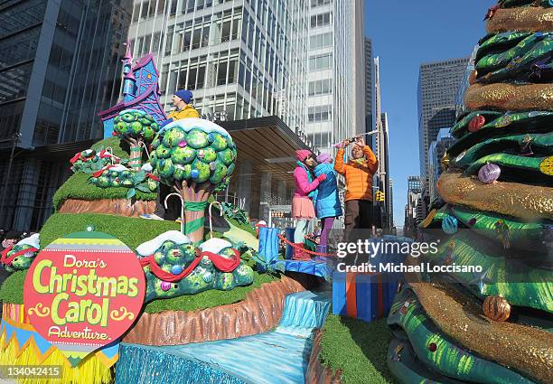 Twist, Marina, Kiki, Shout of The Fresh Beat Band make their way through NYC streets on Dora's Christmas Carol Adventure float during the 85th Annual...