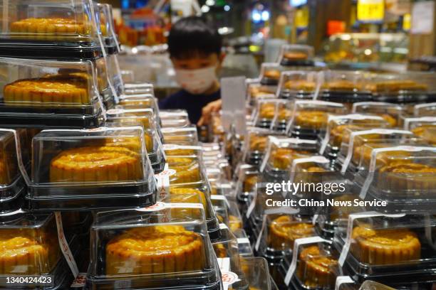 Child watches mooncakes at a supermarket before the Mid-Autumn Festival on September 14, 2021 in Zhengzhou, Henan Province of China.