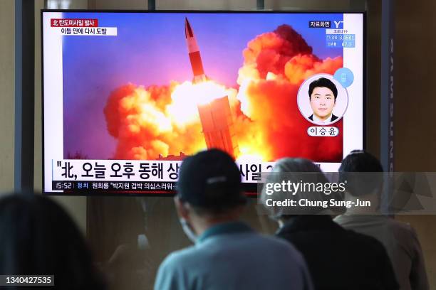 People watch a TV at the Seoul Railway Station showing a file image of a North Korean missile launch, on September 15, 2021 in Seoul, South Korea....