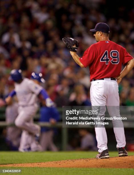 Red Sox starting pitcher Tim Wakefiled waits for the ball after giving up a grand slam to Royals shortstop Yuniesky Betancourt, left, in the fourth...