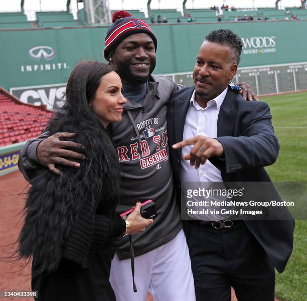 Boston Red Sox designated hitter David Ortiz walks with Manny Ramirez's wife Juliana Ramirez and Manny Ramirez, Manny and others from the 2004 World...