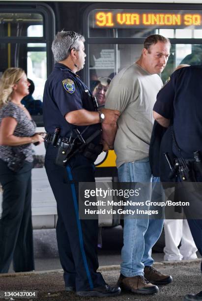 Man is held as a suspect in the robbery of the Cambridge Savings Bank today, May 29, 2012. He was captured in an MBTA bus here on Washington St. In...