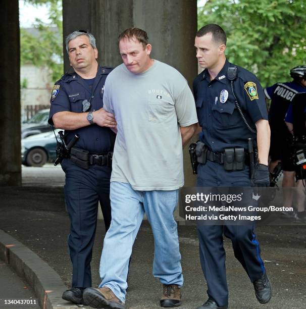 Man is held as a suspect in the robbery of the Cambridge Savings Bank today, May 29, 2012. He was captured in an MBTA bus here on Washington St. In...