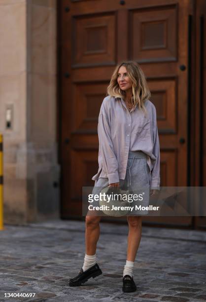 Sue Giers wearing SoSue beige blouse, grey short, Bottega Veneta mini Jodie bag and black celine loafer on September 09, 2021 in Berlin, Germany.