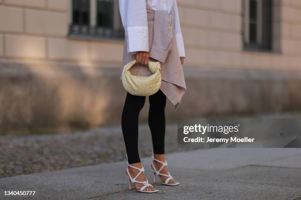 Sue Giers wearing Bottega Veneta white sandals, SoSue White blouse, black leggins and beige jacket and Bottega Veneta mini Jodie bag on September 09,...