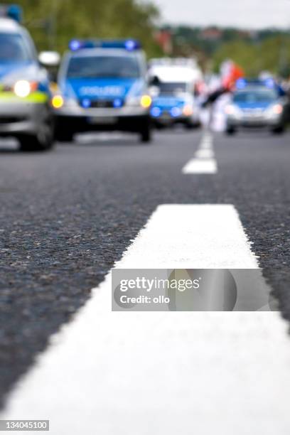 numerous police cars - road marking, selective focus - germany police stock pictures, royalty-free photos & images