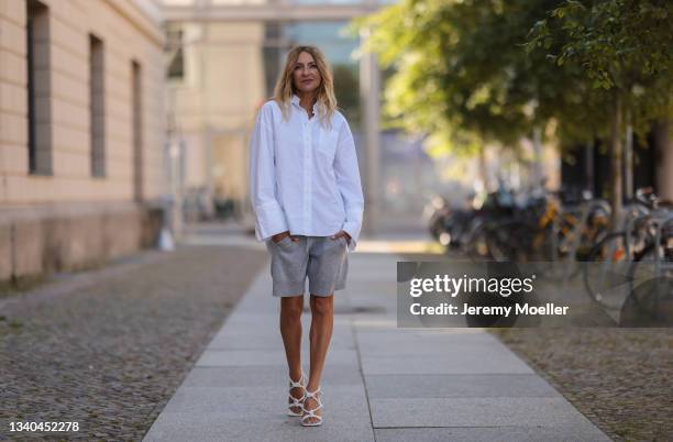 Sue Giers wearing Bottega Veneta white sandals, SoSue white blouse and grey shorts on September 09, 2021 in Berlin, Germany.