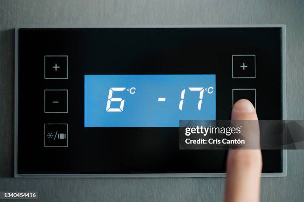 close up of finger adjusting fridge temperature - temperature control stock pictures, royalty-free photos & images
