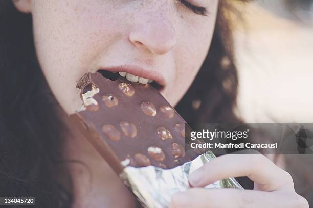 girl eating chocolate - chocolate closed eyes stock-fotos und bilder