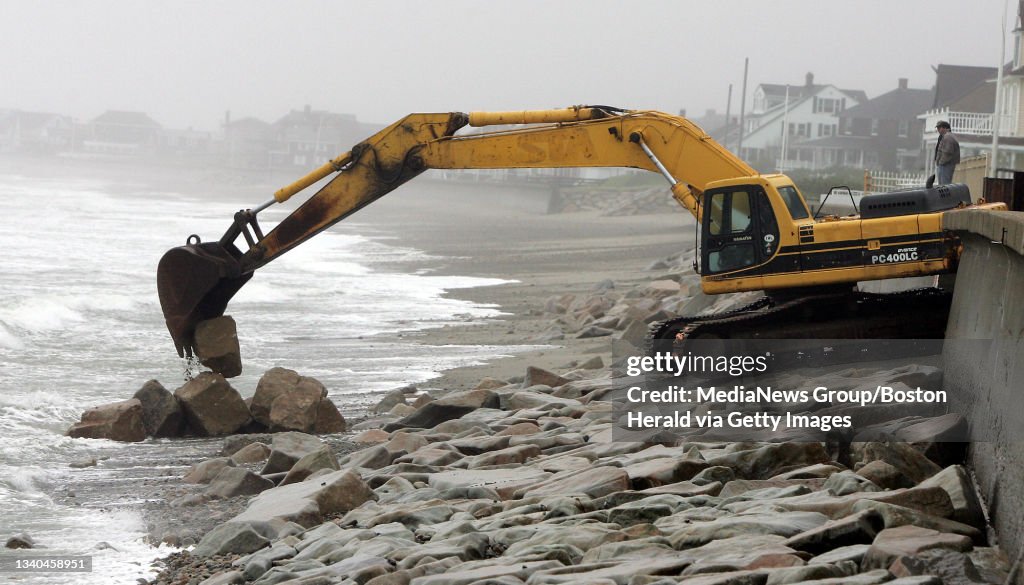 (5/25/05 Marshfield, MA) A backhoe lays down some boulders along Green Harbor Beach in Marshfield to reinforce the seawall which had pulled away in some areas as the Noreaster of May 2005 takes its toll on the South Shore. (HC2D0421.JPG - Staff Pho