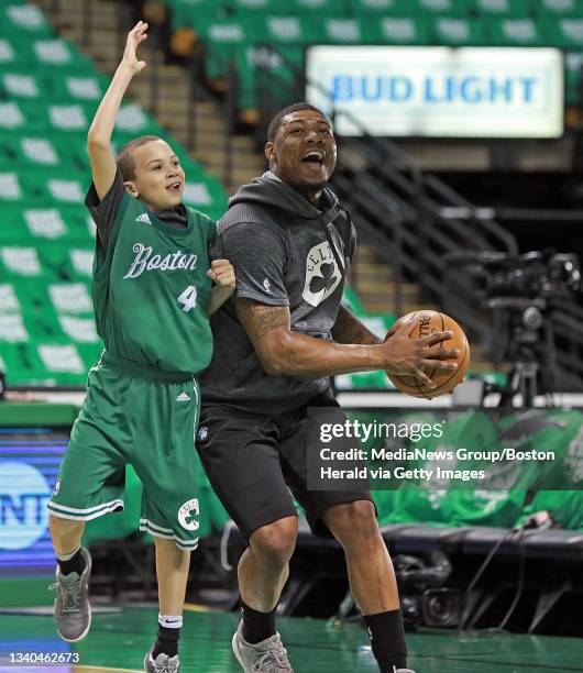 Boston Celtics guard Marcus Smart scrimmages with Celtics assistant Micah Shrewsberry's son Nick, before Game 6 of the NBA Eastern Conference Finals...