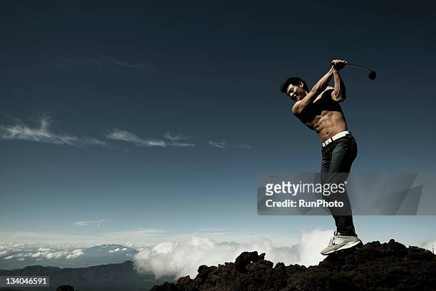 young man training in the mountain,golf - golf short iron stock pictures, royalty-free photos & images