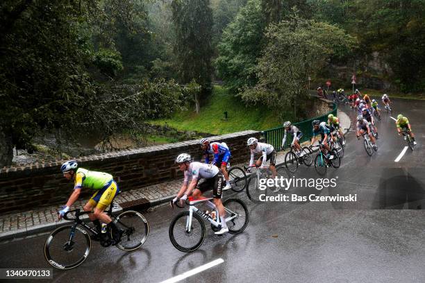 Cedric Beullens of Belgium and Team Sport Vlaanderen - Baloise and Bob Jungels of Luxembourg and AG2R Citröen Team compete in the rain during the...