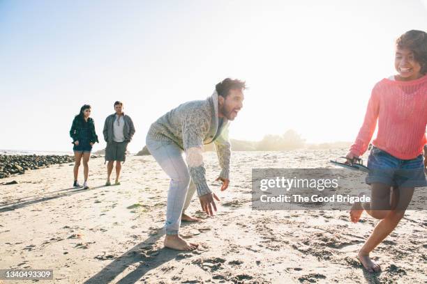 father playing with daughter at beach during vacation - active lifestyle los angeles stock pictures, royalty-free photos & images
