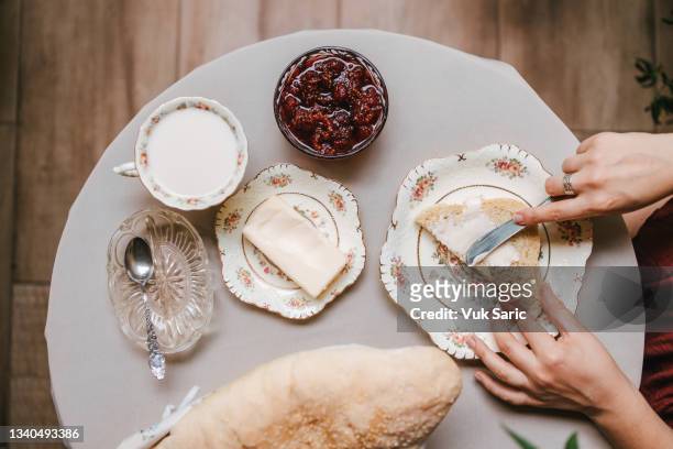 woman spreading butter on the homemade bread - buttering stock pictures, royalty-free photos & images