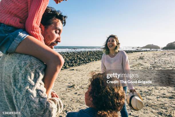 cheerful family spending leisure time at beach on sunny day - 5-10 2016 stock pictures, royalty-free photos & images