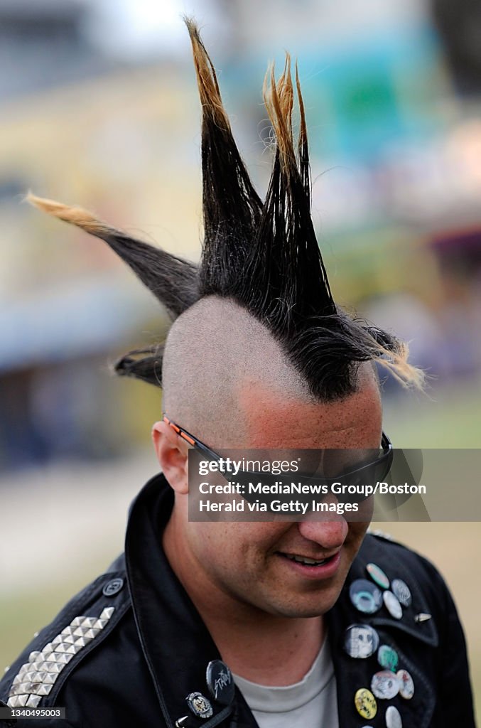 A man sports a liberty spike mohawk while handing out under the palm... News Photo - Getty Images A man sports a liberty spike mohawk while handing out under the palm... News Photo - Getty Images