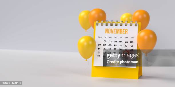 yellow 26th november thanksgiving day desk calendar 2022 with ballons on blank background with copy space. - thanksgiving holiday hours stock pictures, royalty-free photos & images