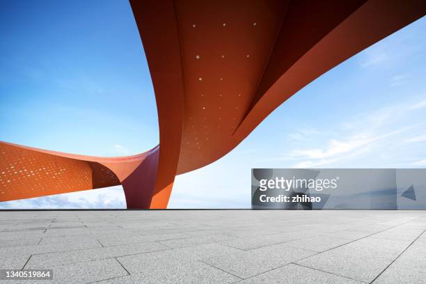 red abstract decorative buildings and empty squares on sunny days - architectuur stockfoto's en -beelden