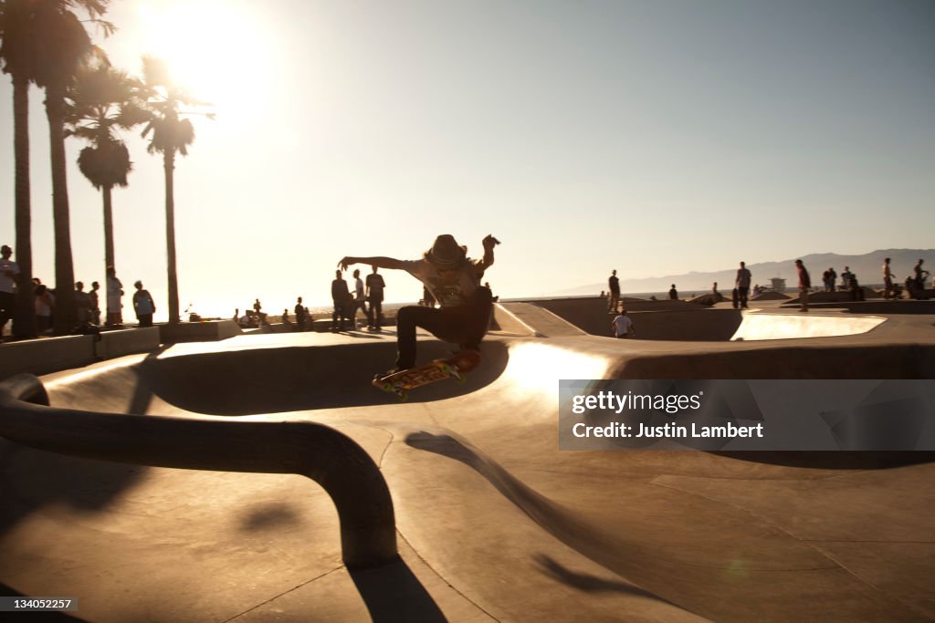 YOUTH PULLING TRICK IN SKATEPARK IN L.A