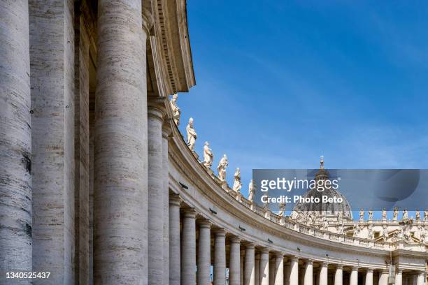 the majestic bernini's colonnade in the square of st. peter's basilica in the heart of rome - basiliek stockfoto's en -beelden
