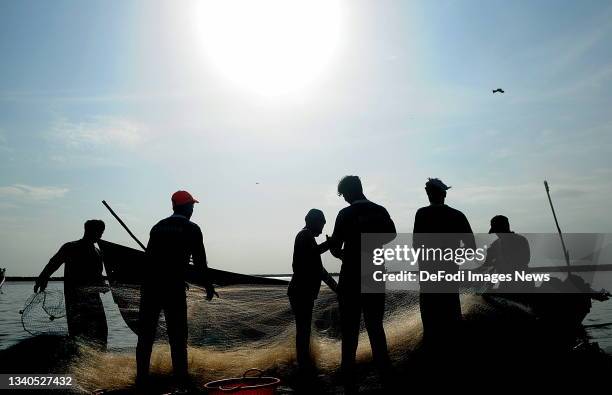 Kozhikode, India Fishermen separate the fish caught in the net at Vellayil Fishing Harbour on September 15, 2021 in Kozhikode, India. As the cases of...