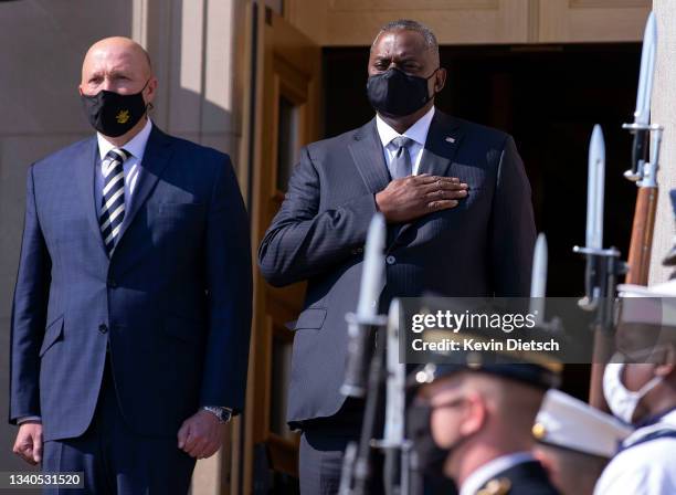 Secretary of Defense Lloyd Austin and Australian Minister for Defense Peter Dutton stand for their national anthems during an honor cordon at the...